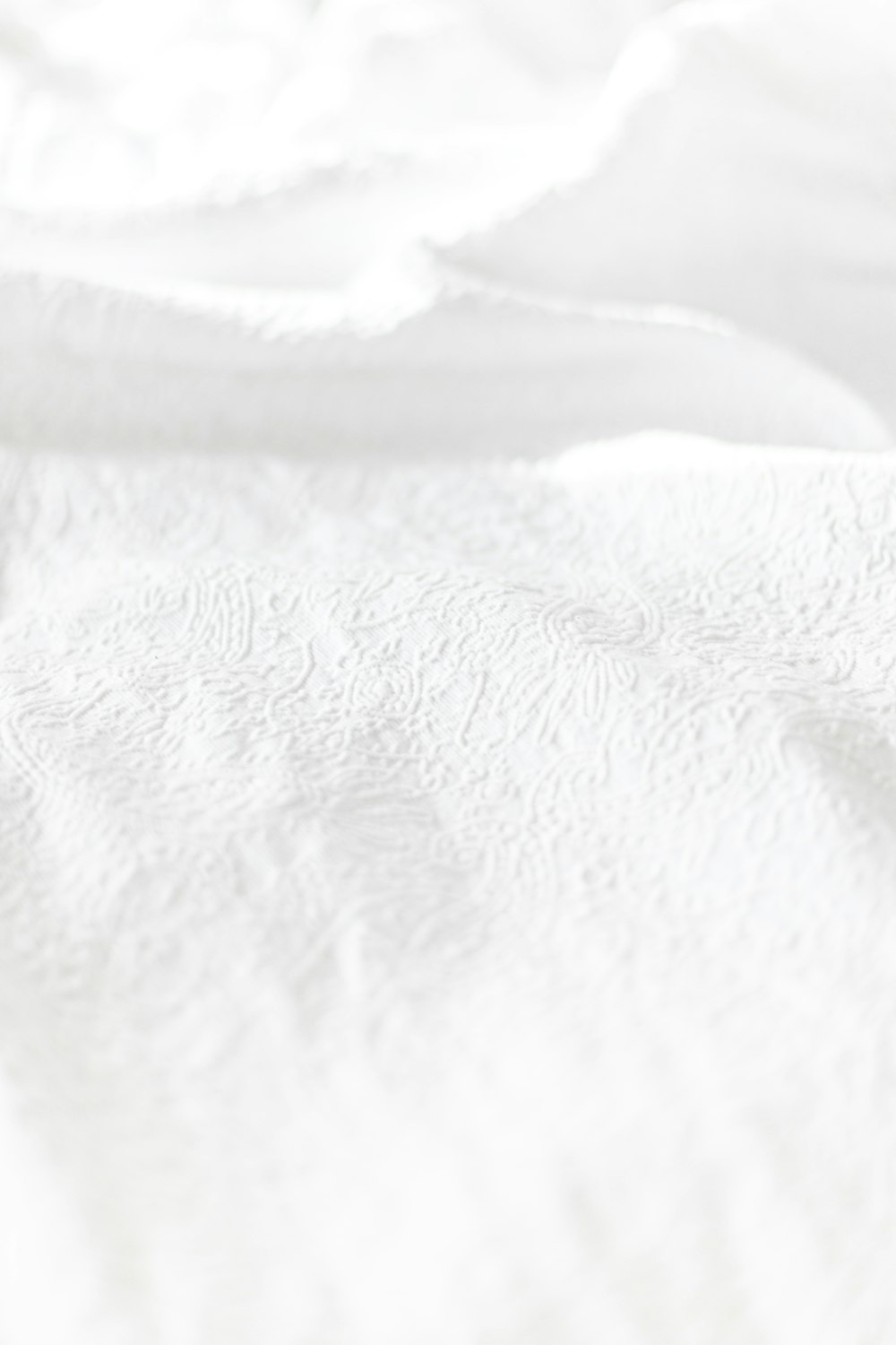 white textile on brown wooden table