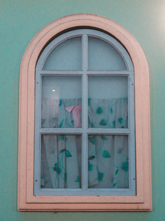 Two-leaf window painted in a soft pastel blue with transparent glass.