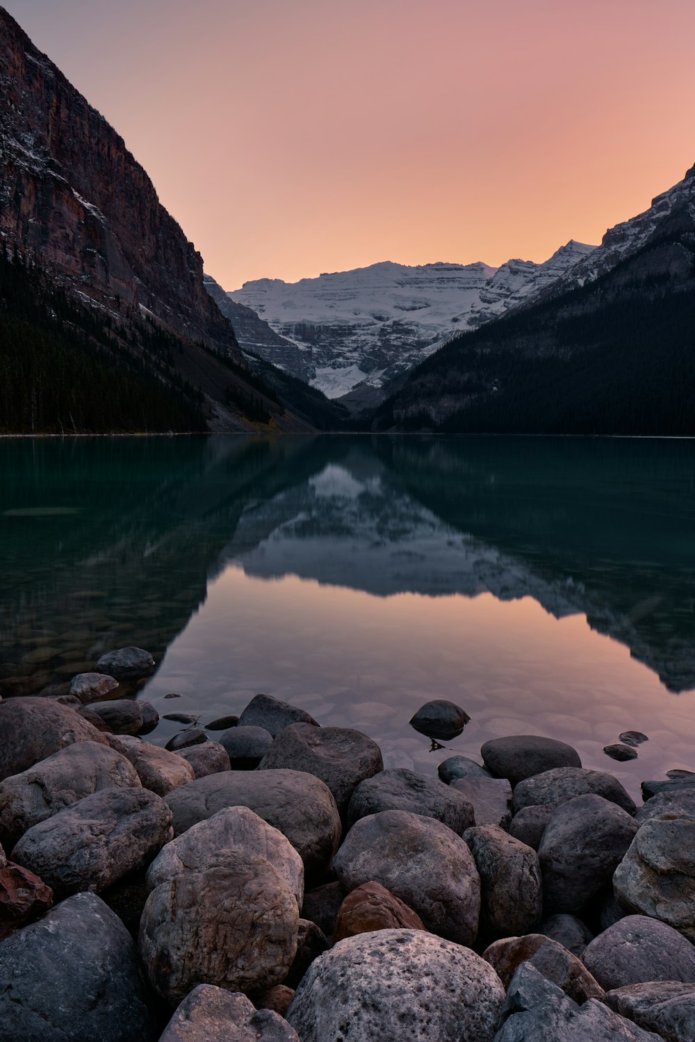 lake near mountain during daytime