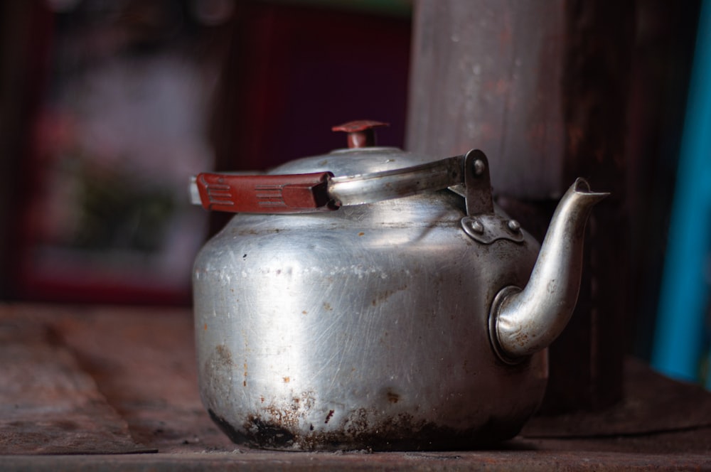 white ceramic teapot on brown wooden table