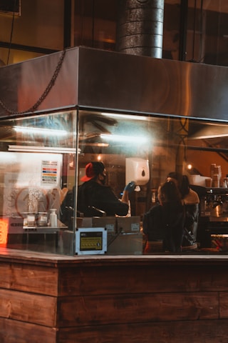 A friendly consultant reviewing charts and data with a small cafe owner in a cozy shop setting.