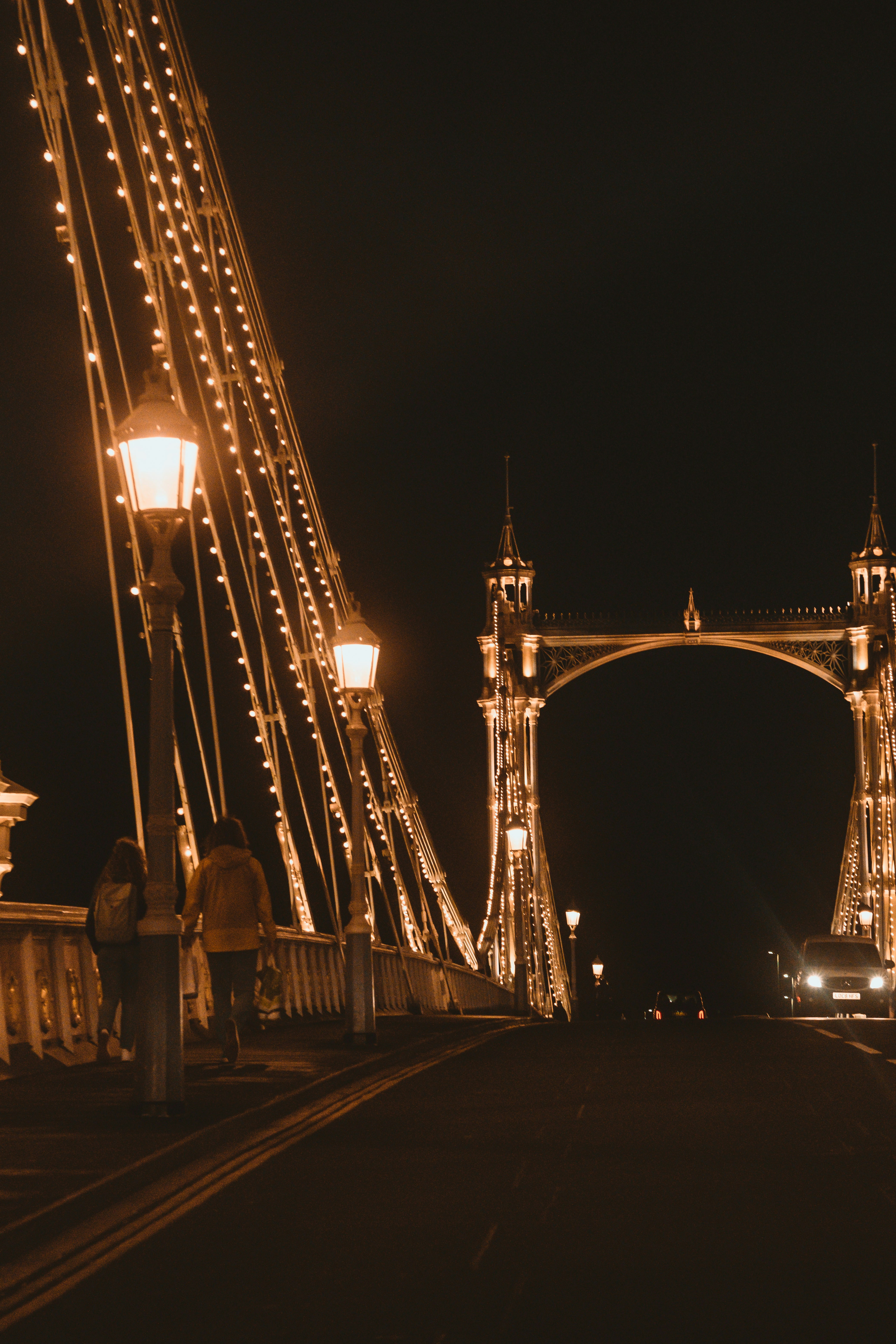 people walking on bridge during night time