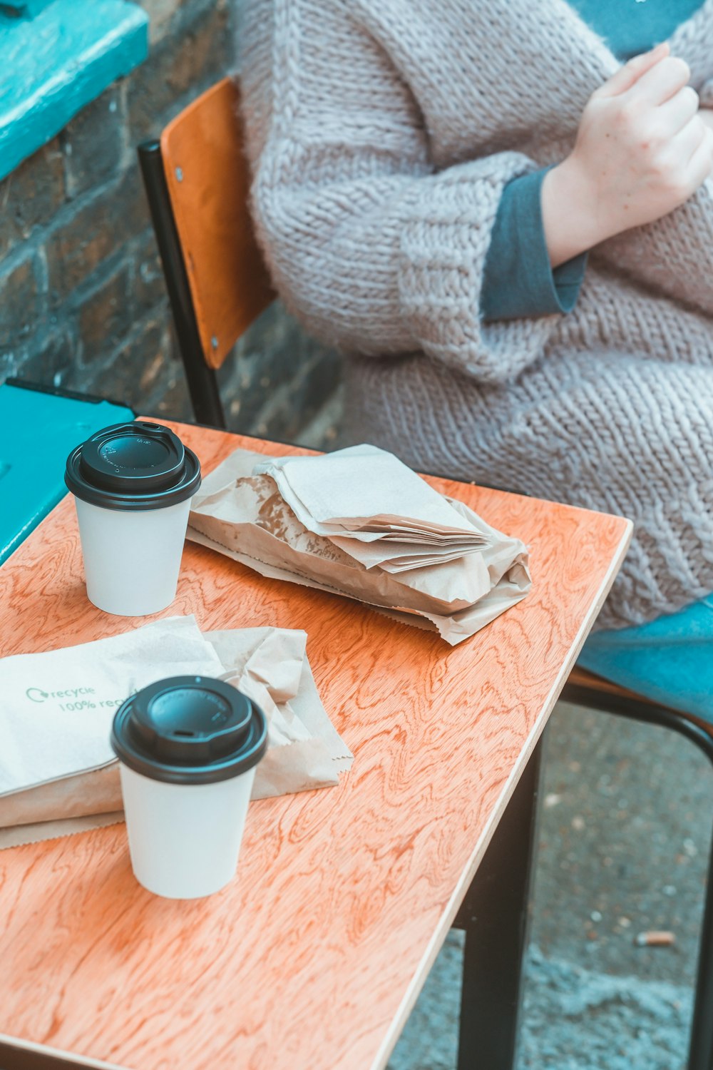 white and black plastic cup on brown paper