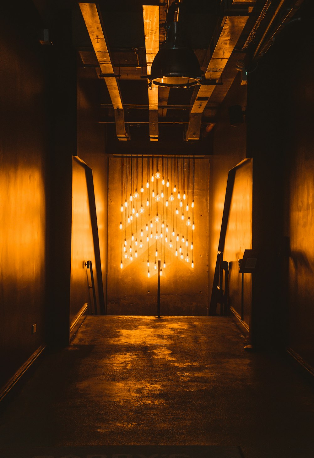 a dimly lit room with a cross in the middle