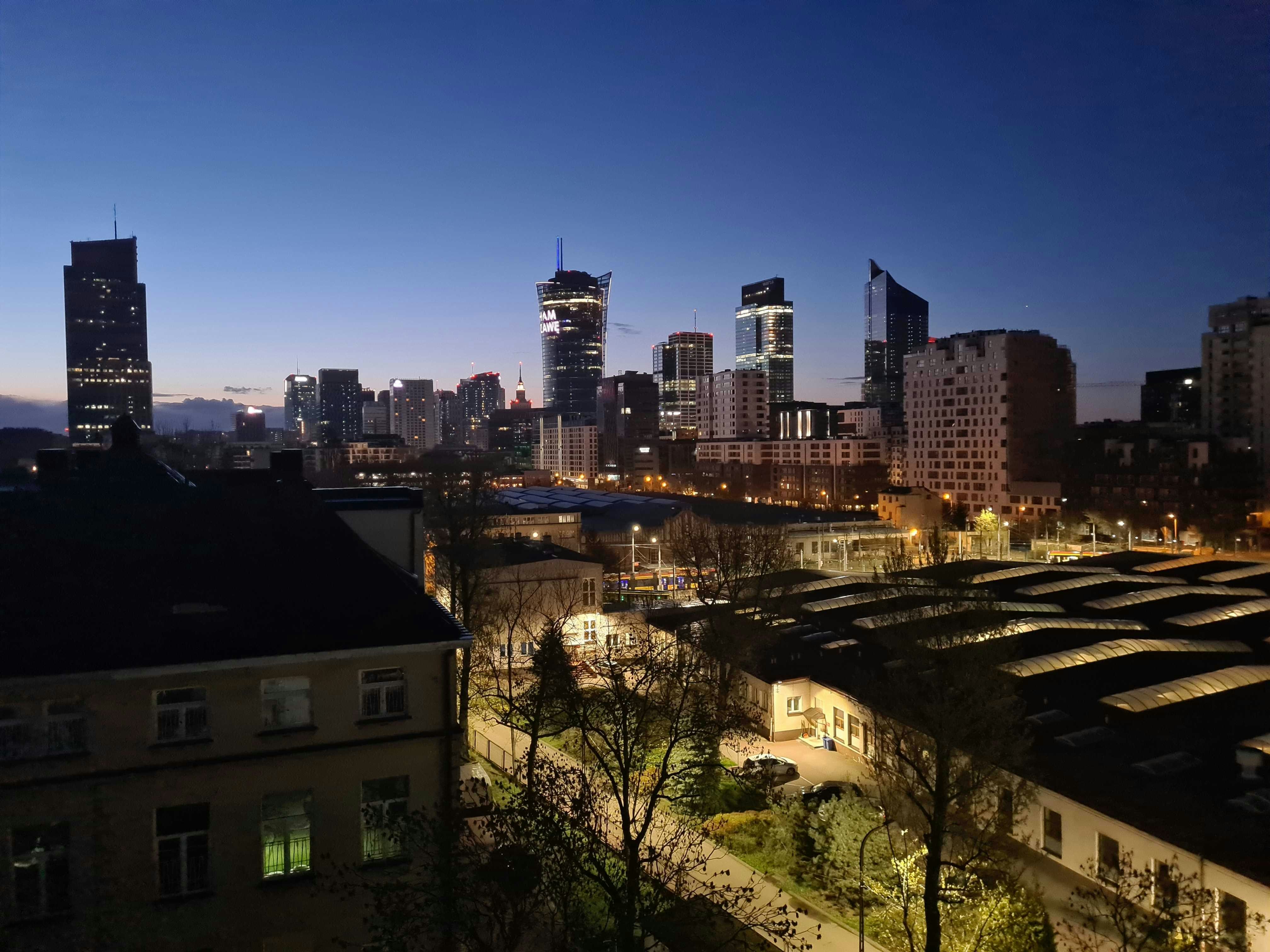 high rise buildings during night time, Warsaw at dawn (Wola)</p><p>