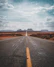 gray asphalt road under cloudy sky during daytime