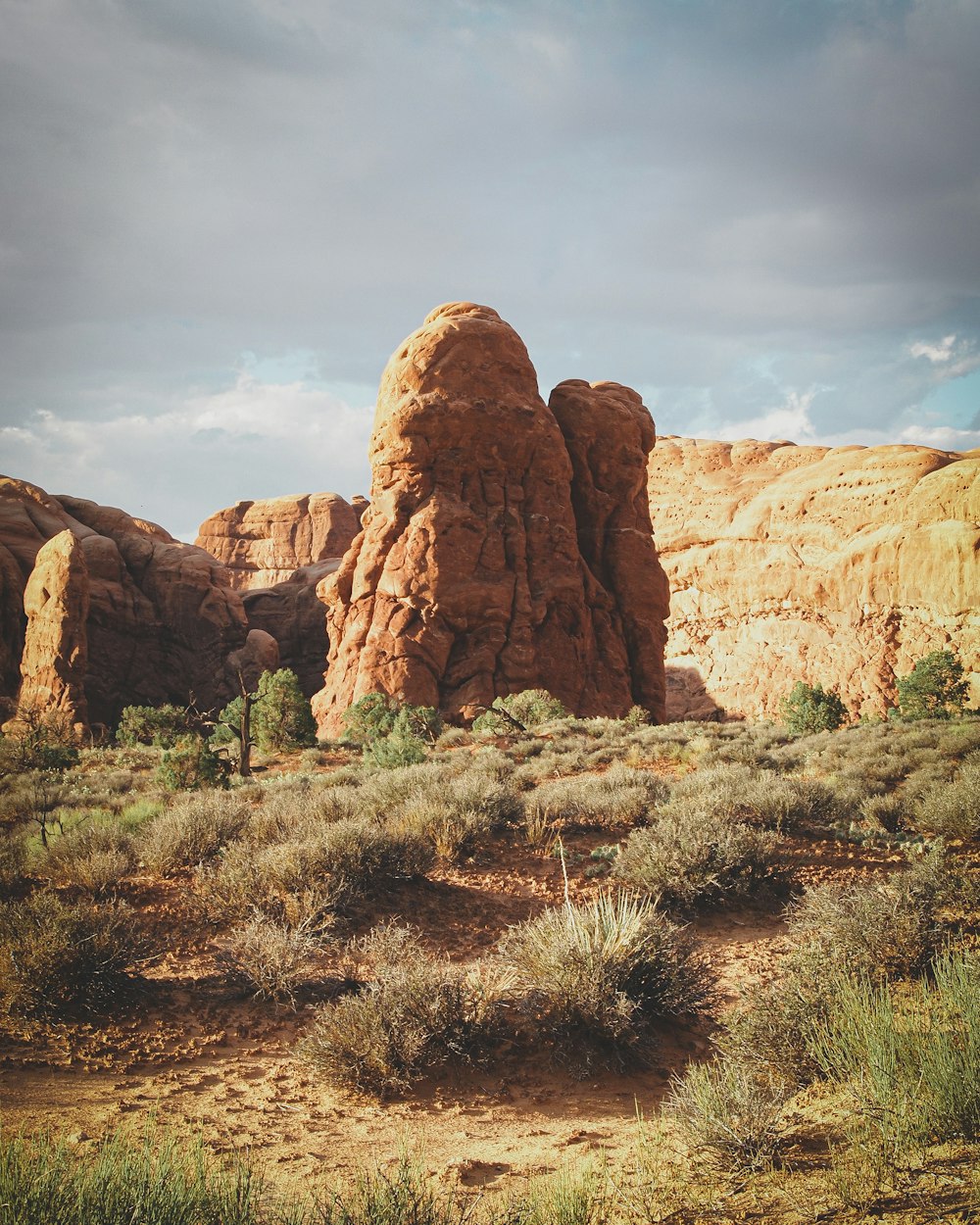 brown rock formation under white clouds during daytime