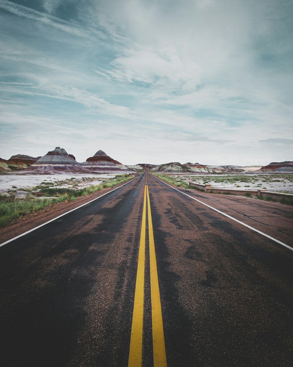 gray asphalt road under blue sky during daytime