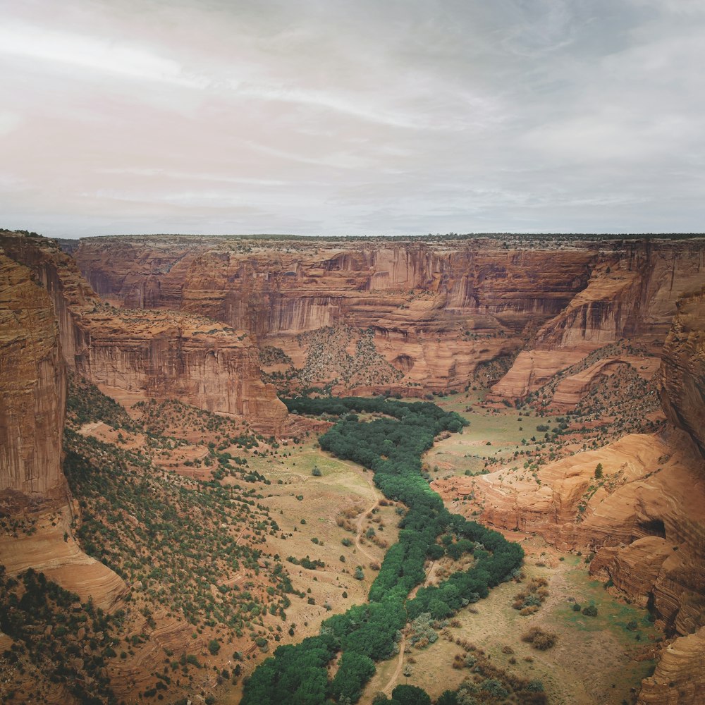 brown rock formation under white clouds during daytime