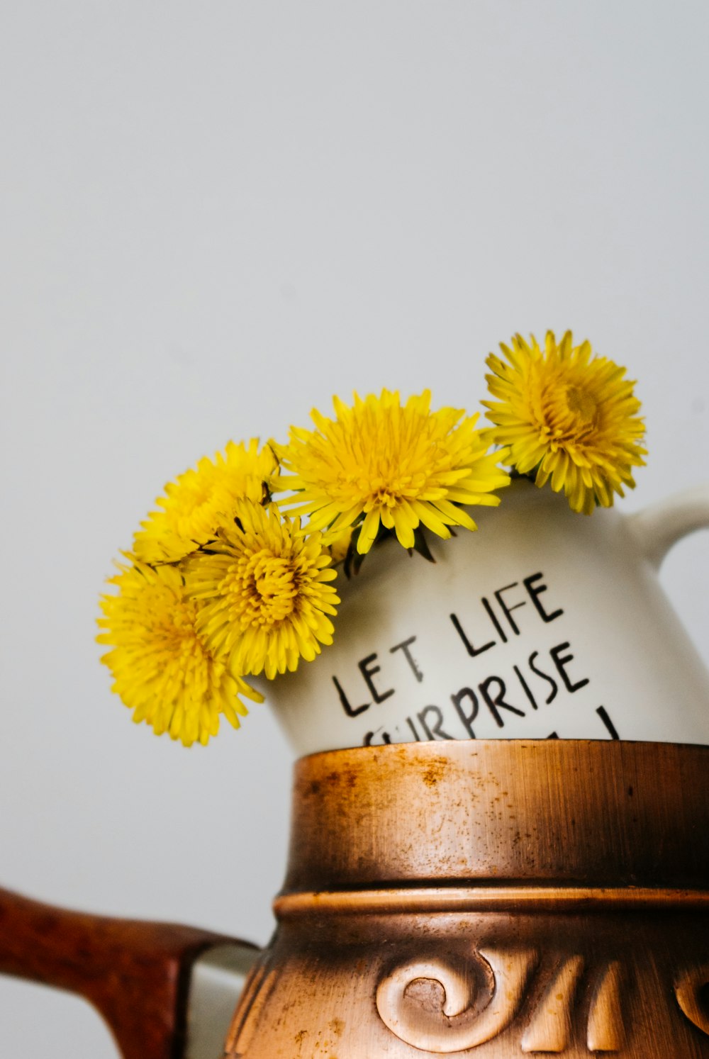 yellow flower on brown ceramic vase