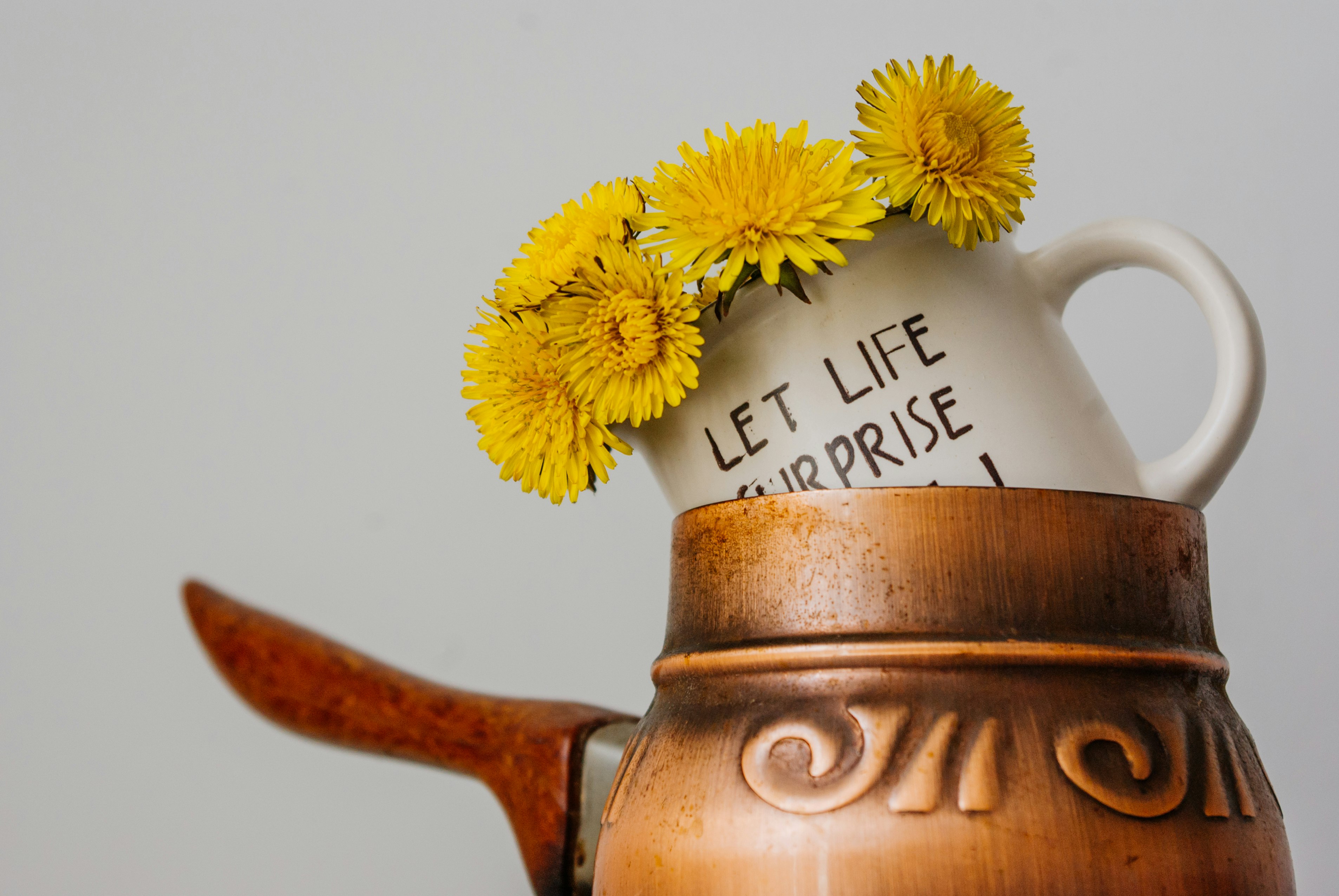 white ceramic teapot with yellow flowers