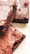 Close-up of a fudgy brownie with a slightly crisp edge on a honey gold plate.