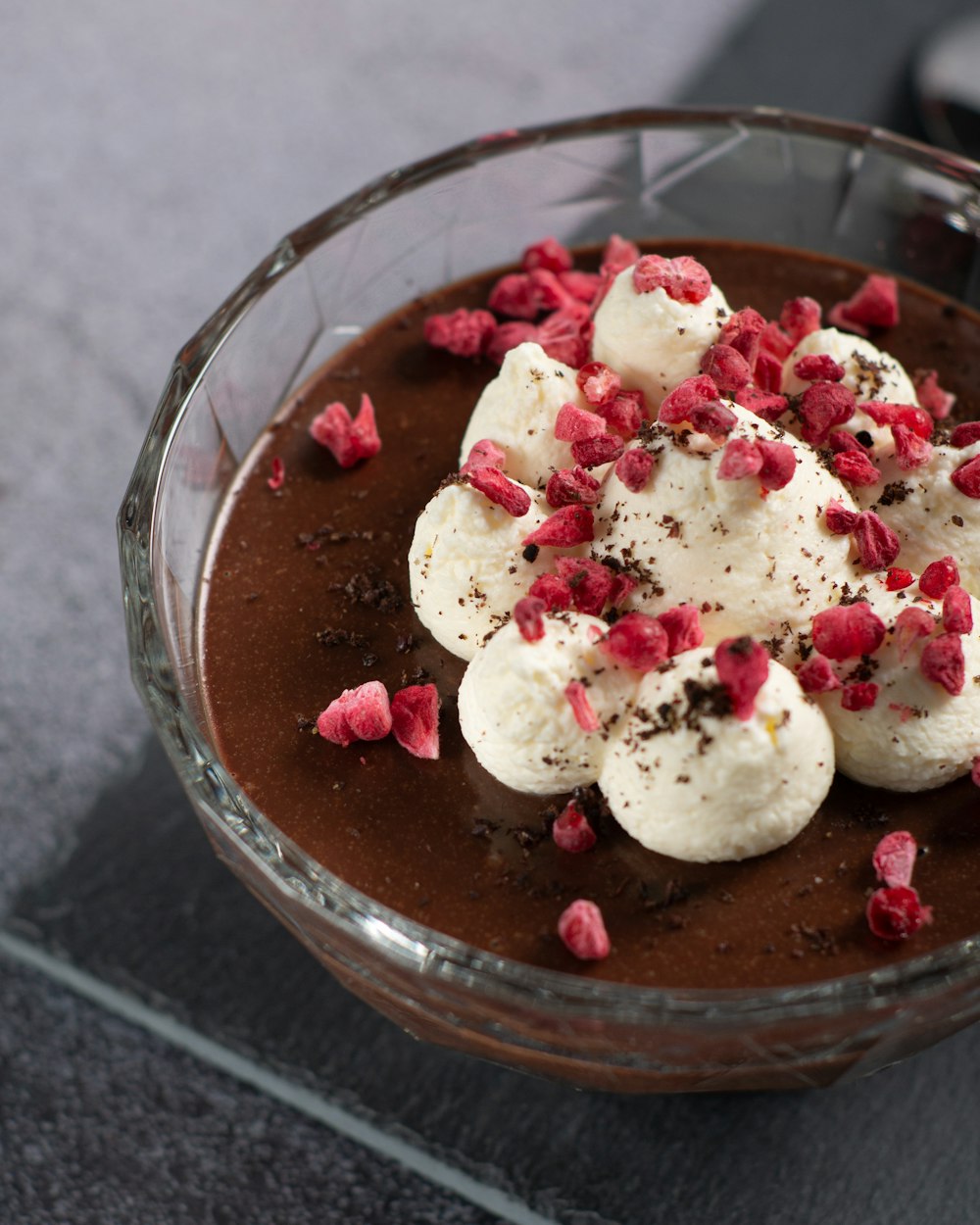 white and red ice cream in clear glass bowl