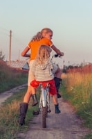woman in white and black stripe dress riding on red motorcycle during daytime