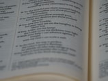 A close-up view of an open book displaying printed text in English. The pages are focused, allowing the text to be read clearly. The paper has a slightly off-white color, typical of many books.