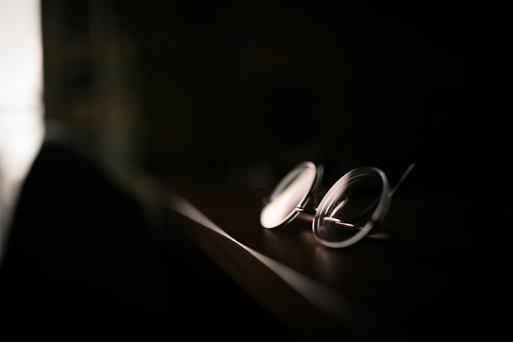 silver wedding band on black background