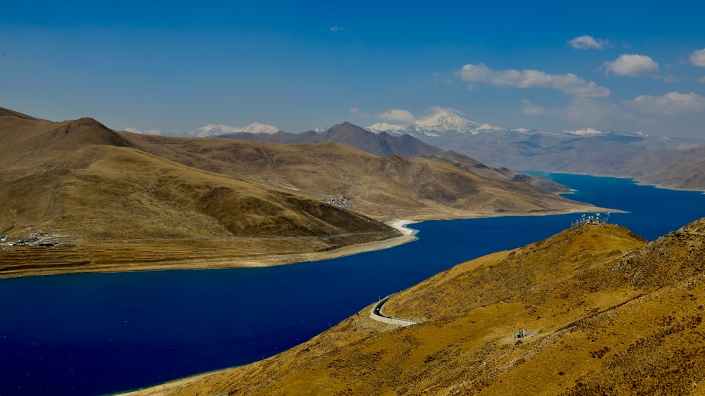 lake in the middle of mountains during daytime