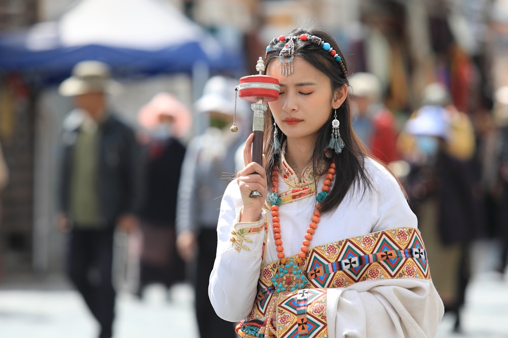 woman in white long sleeve shirt holding smartphone