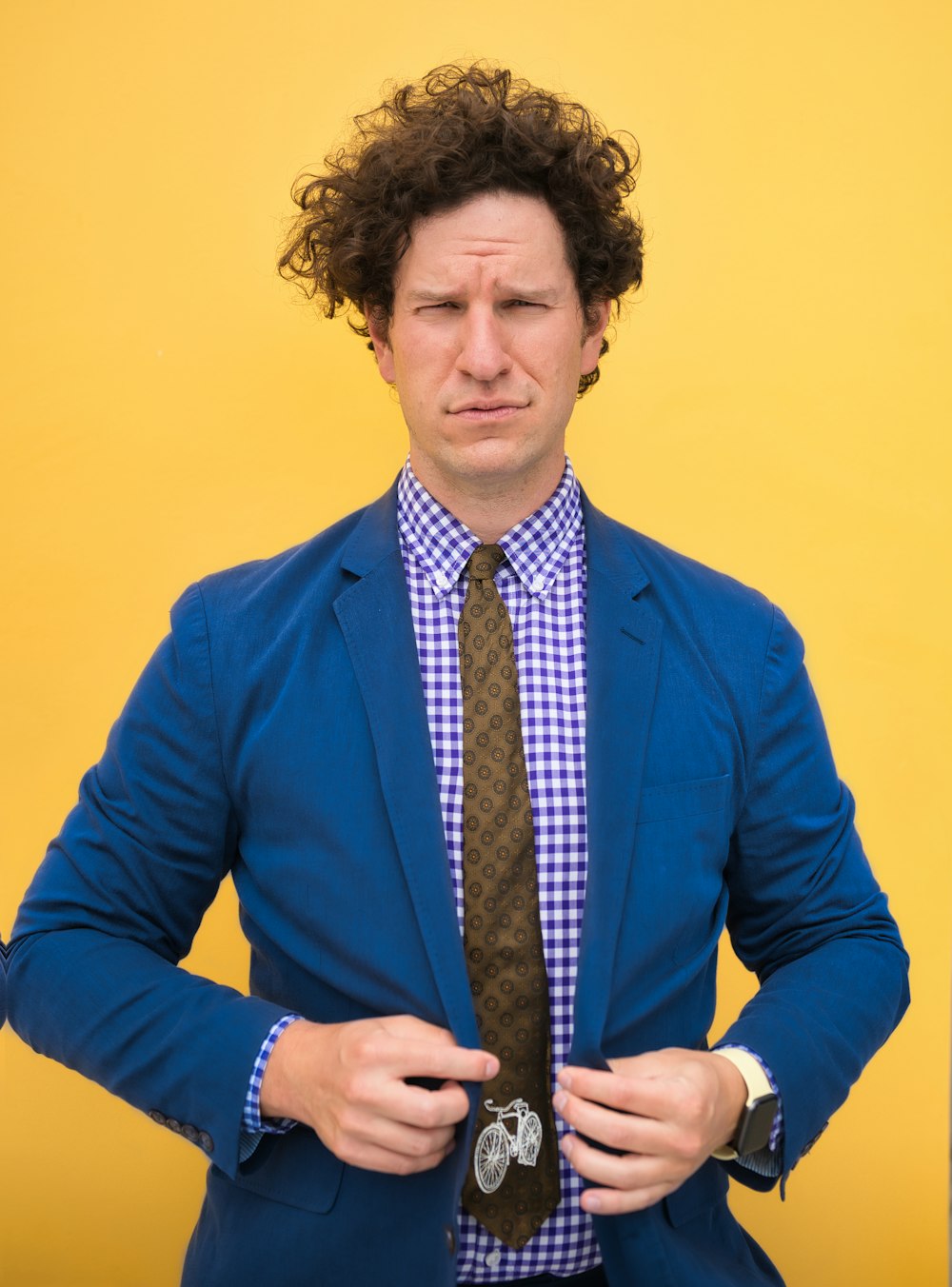 uomo in camicia blu e cravatta marrone