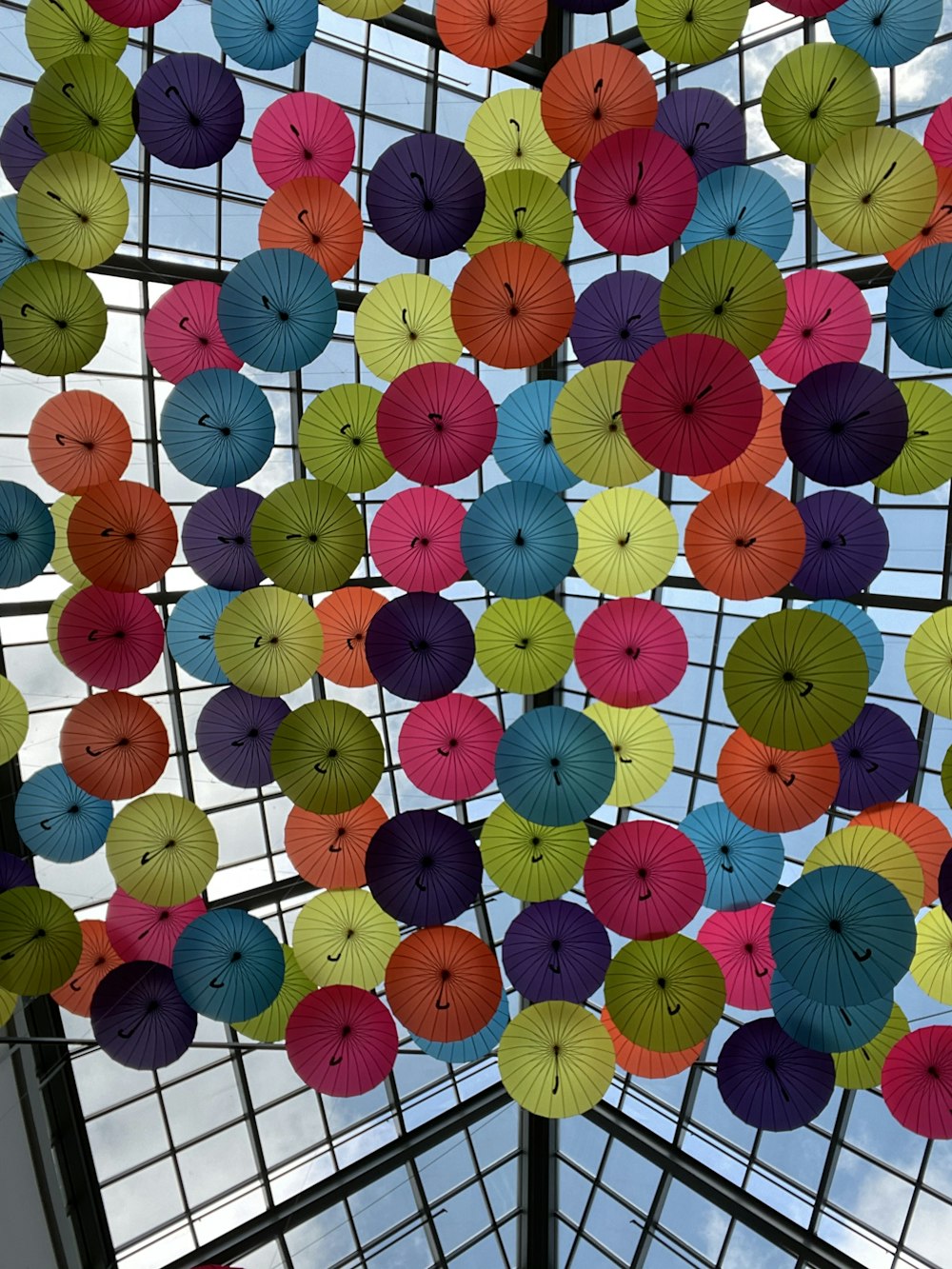 multi colored paper lantern on white metal fence