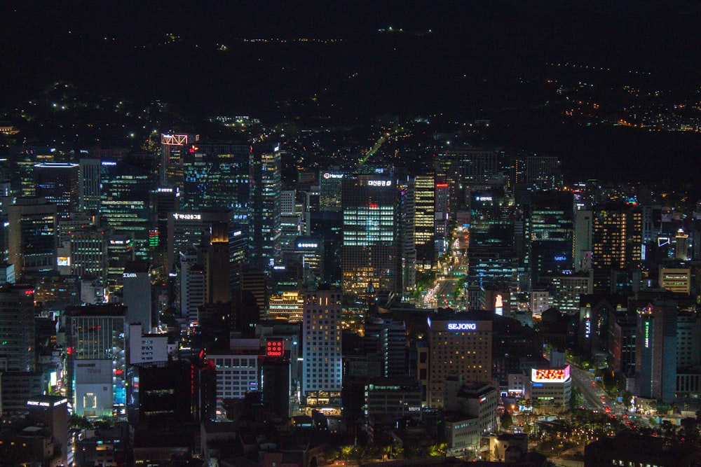 city with high rise buildings during night time