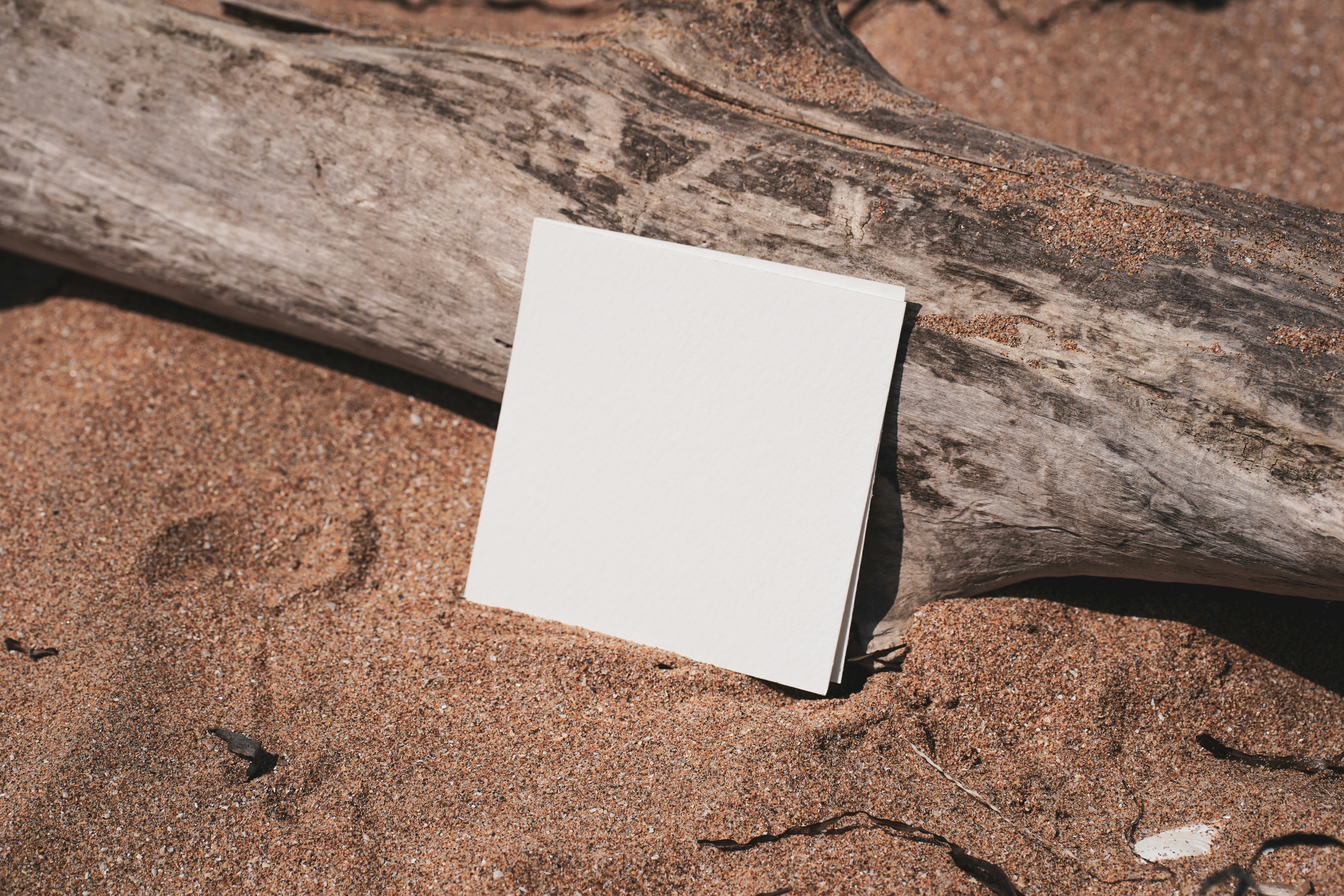 white printer paper on brown sand