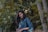 woman in blue denim jacket standing beside tree
