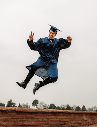 Happy student showing victory symbol