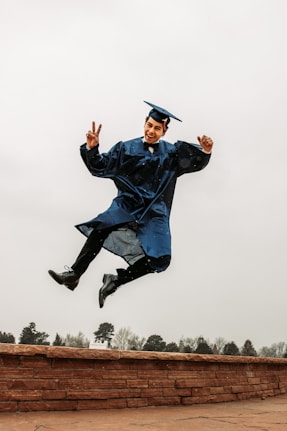 Happy student showing victory symbol