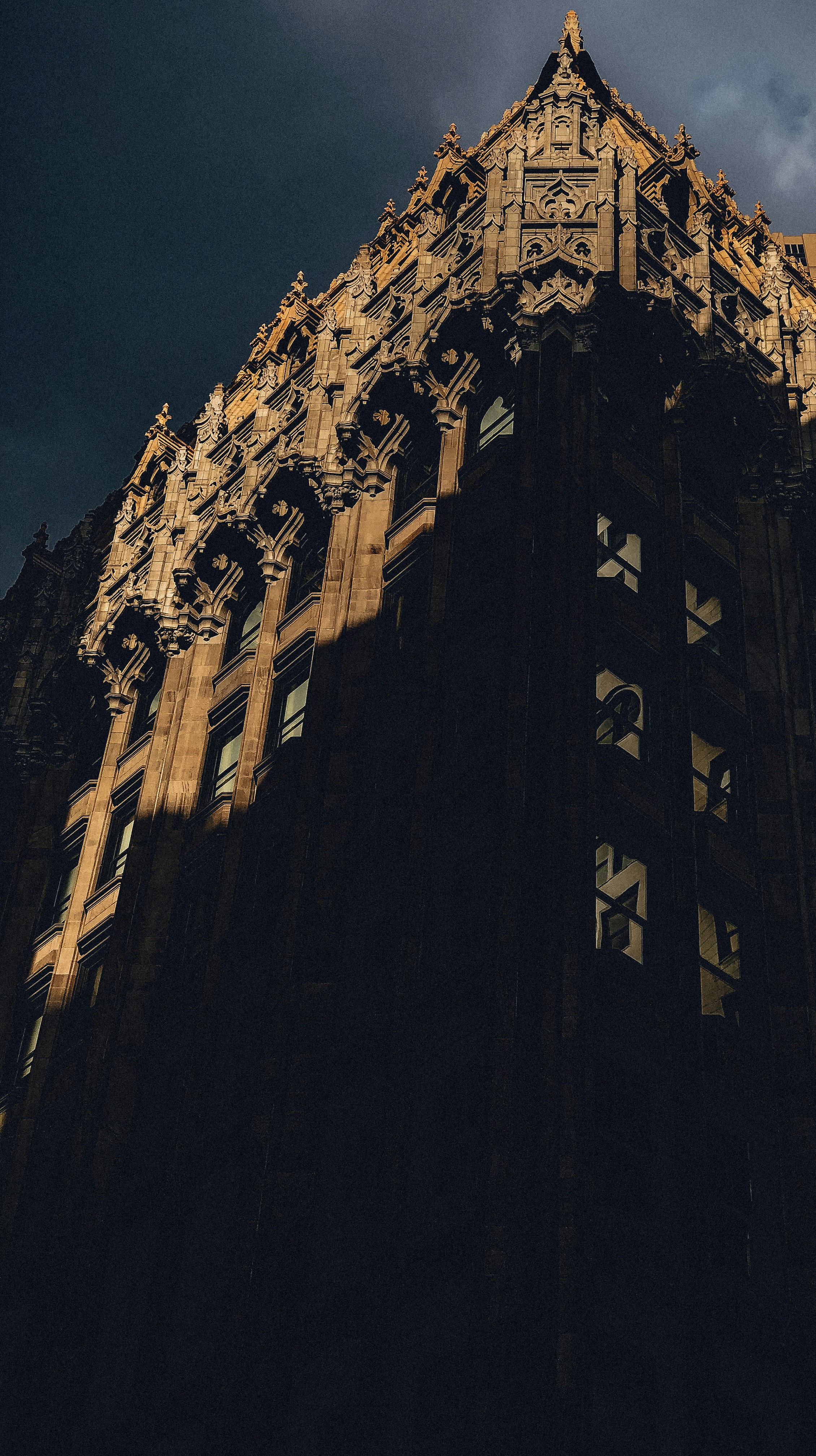 Supreme Court building exterior with dramatic lighting, formal judicial architecture, dark atmospheric sky