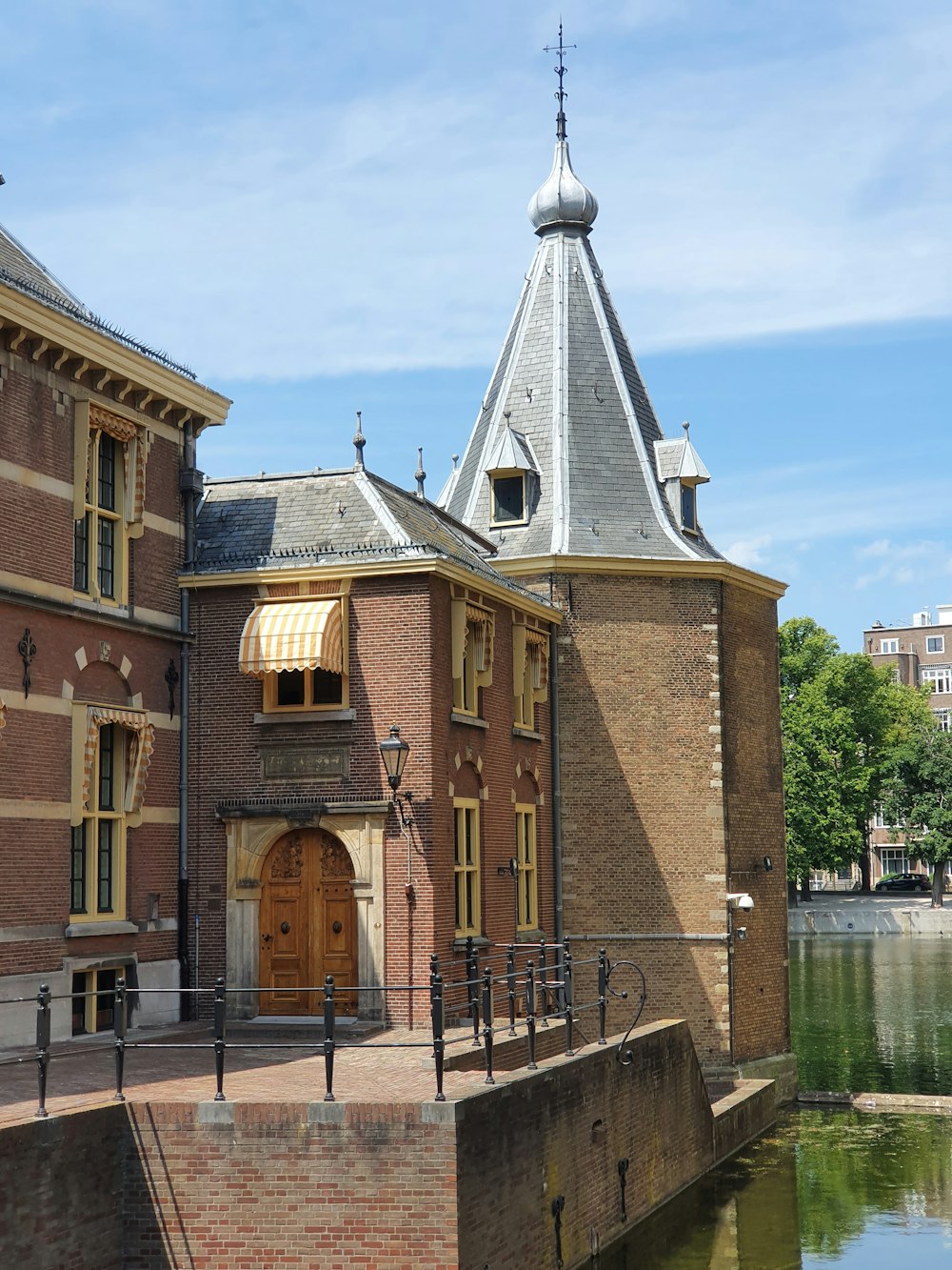 brown concrete building near body of water during daytime