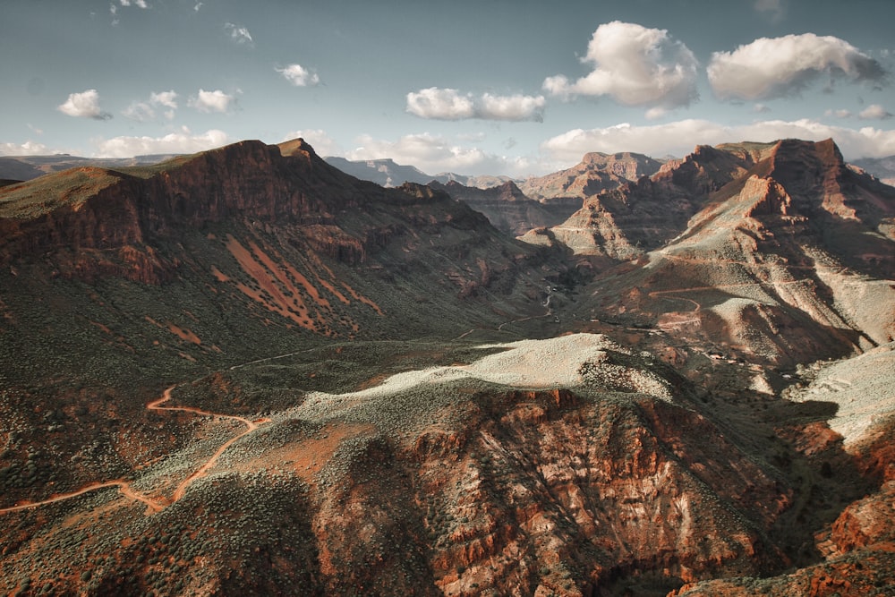 a scenic view of a mountain range with a river running through it