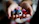 Close-up of a colorful crocheted toy held gently in hands.