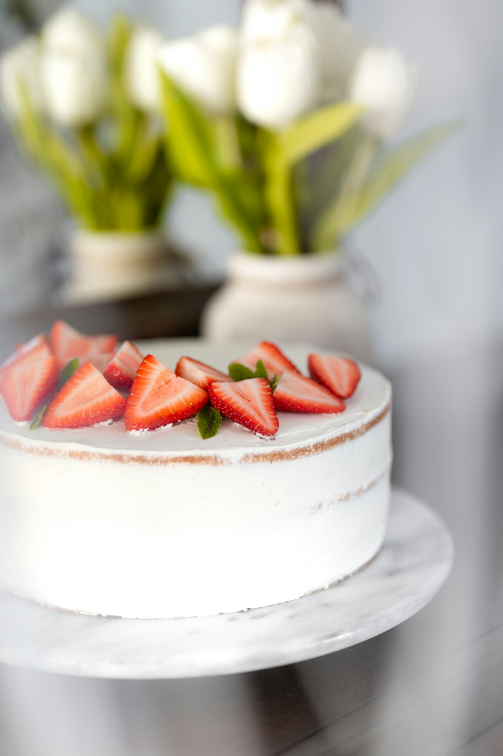 sliced strawberry on white cake