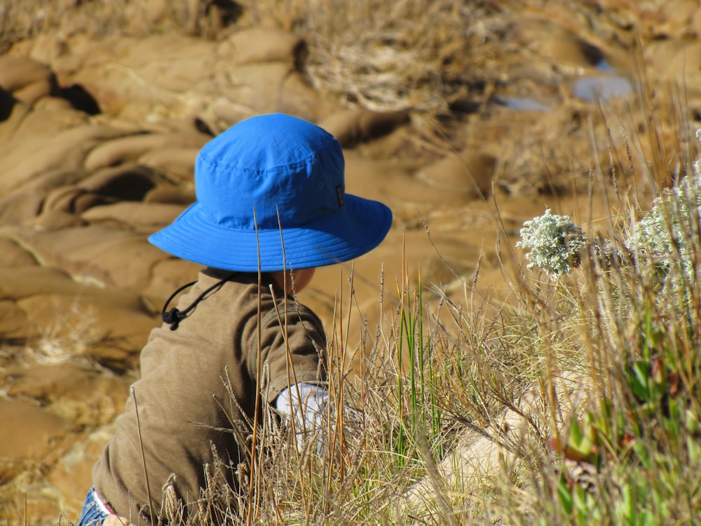 person wearing blue hat and brown pants