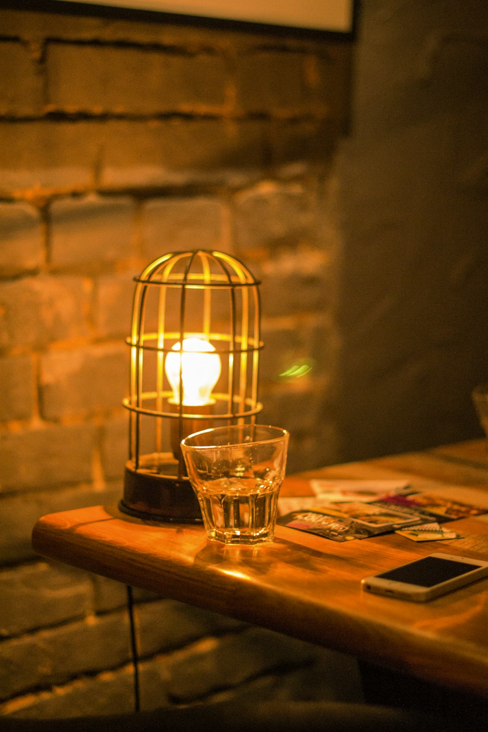 clear glass candle holder on brown wooden table