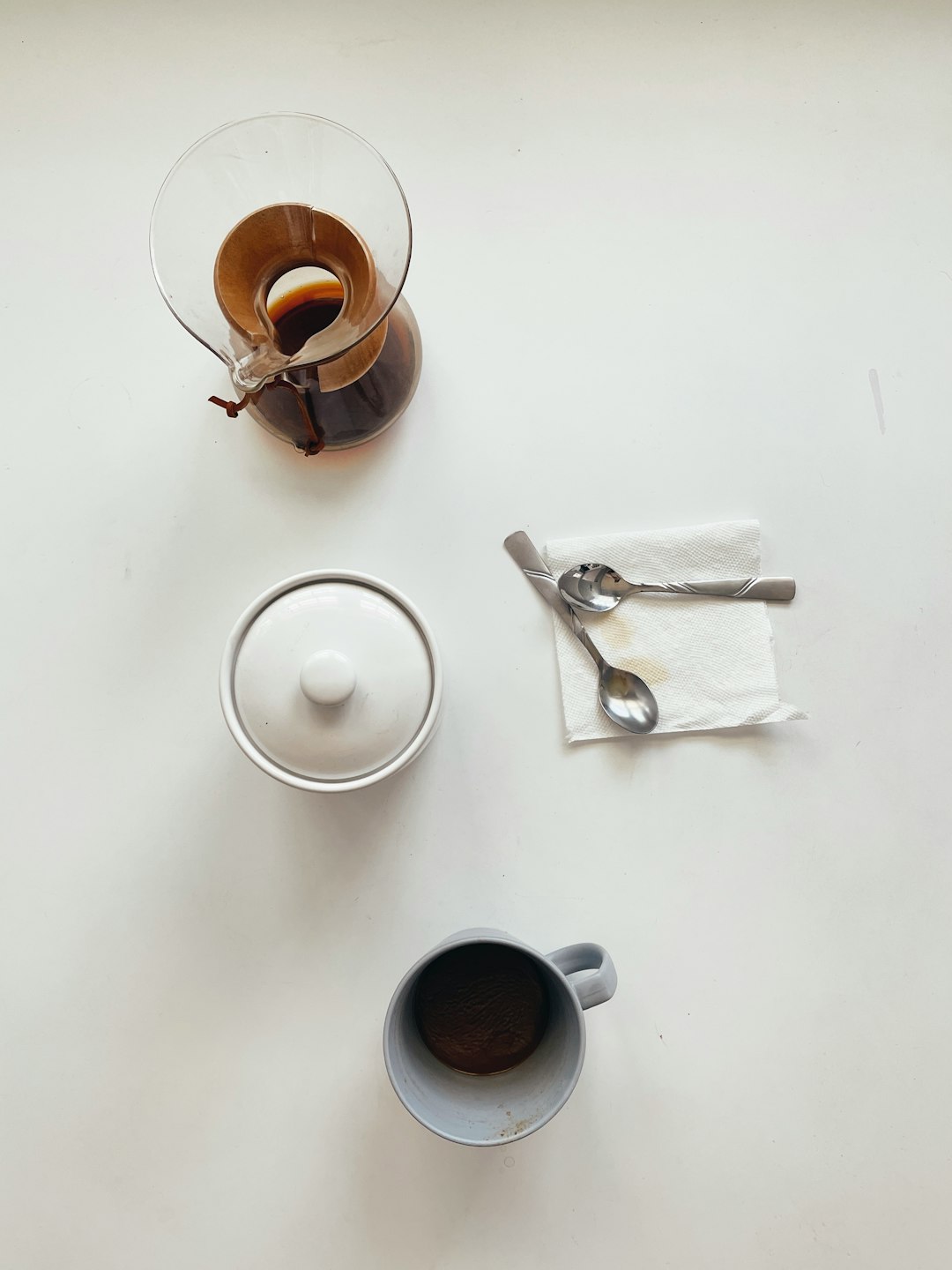 white ceramic mug beside stainless steel scissors