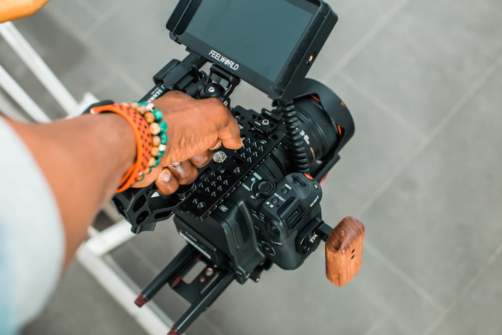 person holding black video camera