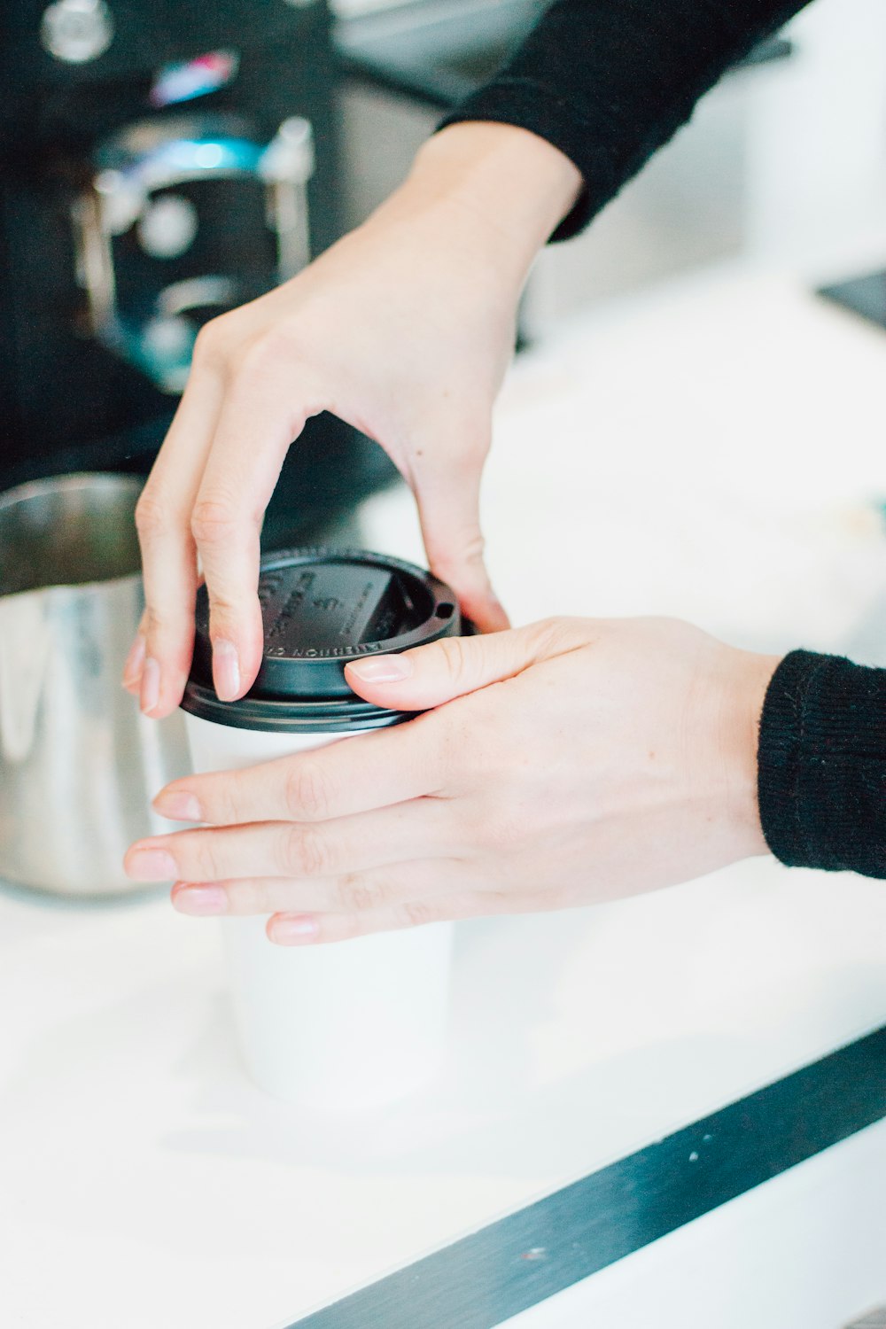 person holding black round device