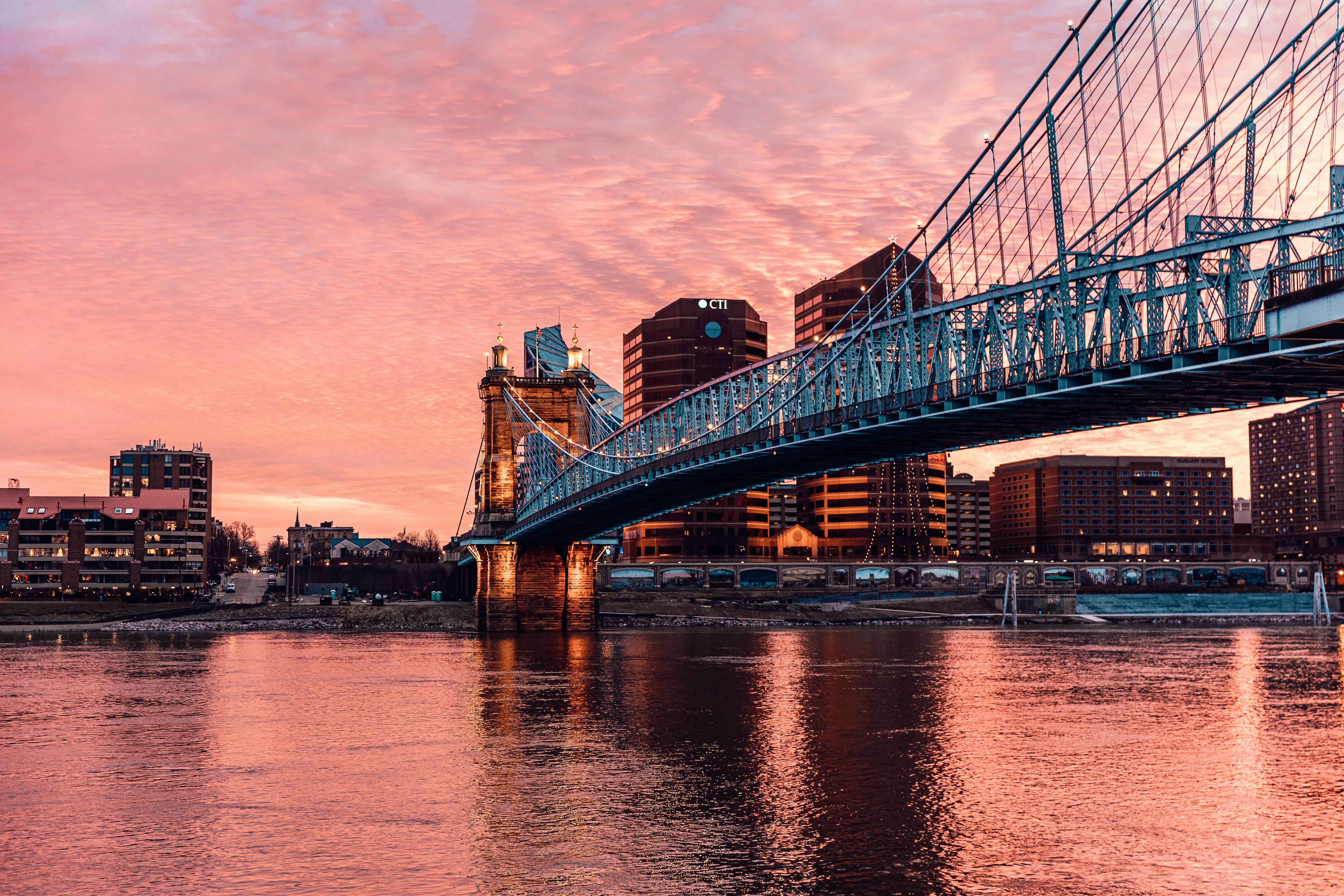 bridge over body of water during sunset