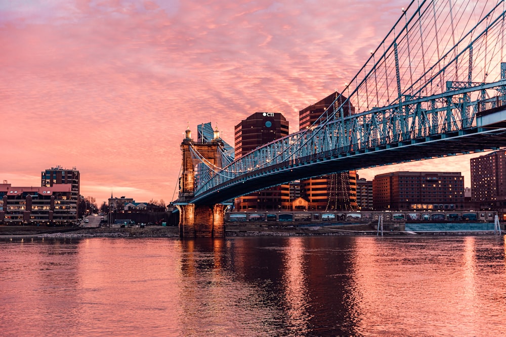 bridge over body of water during sunset