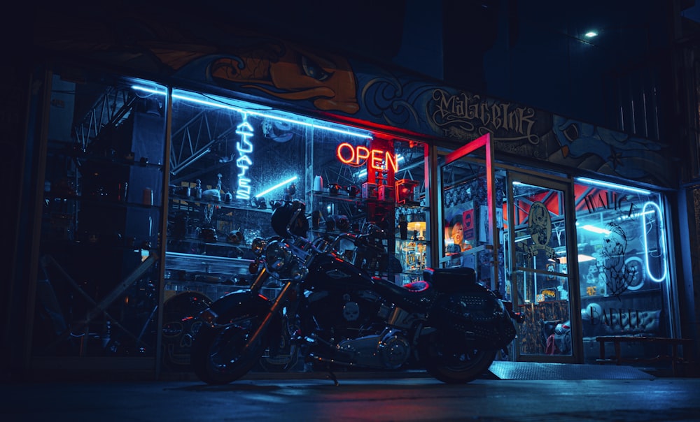 black motorcycle parked beside store during night time