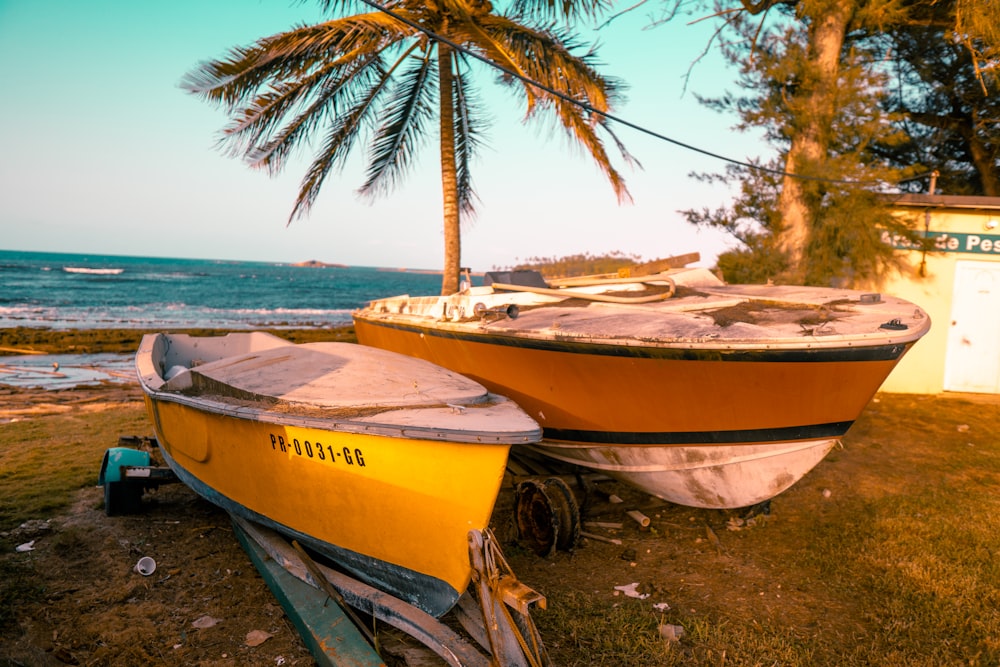 yellow and white boat on beach shore during daytime