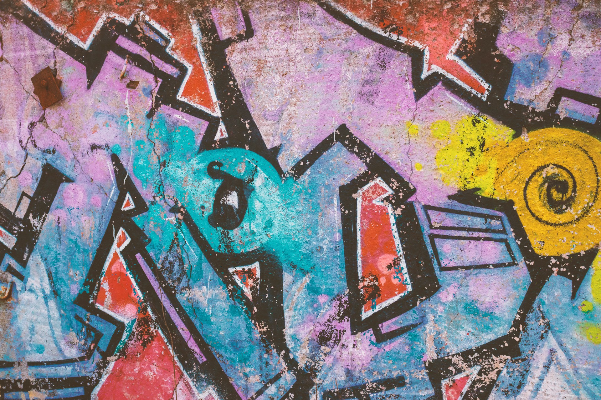 a wall with a bunch of graffiti on it