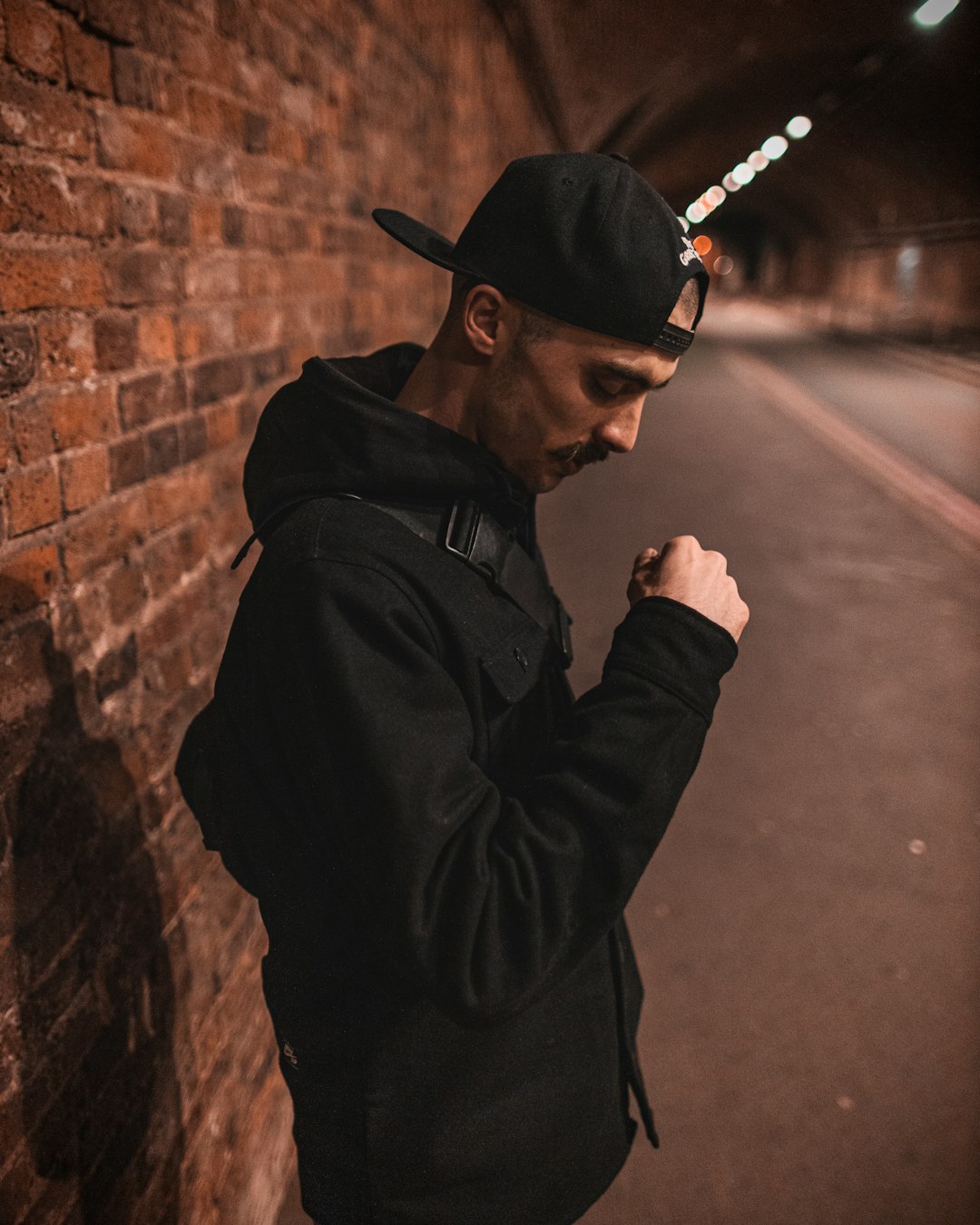 man in black jacket smoking cigarette