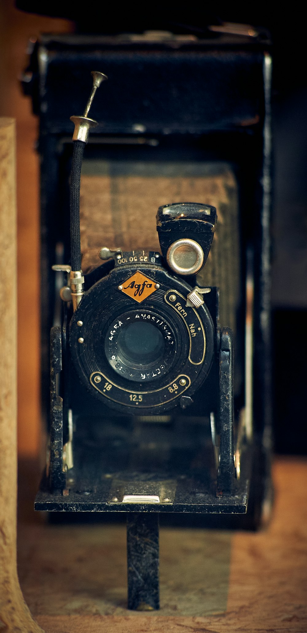 black nikon dslr camera on brown wooden table