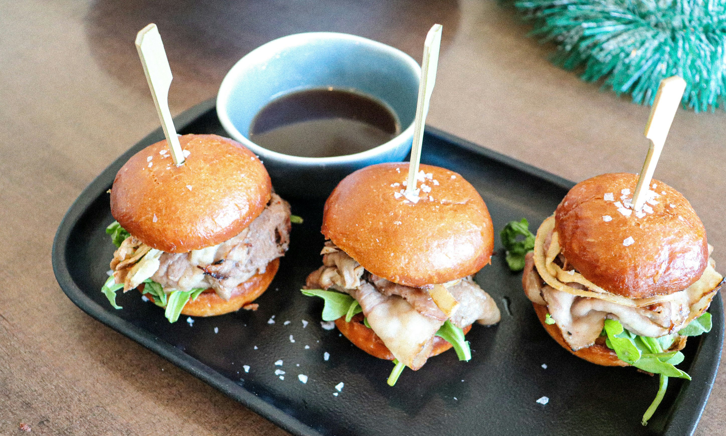 Slider burgers on a black plate