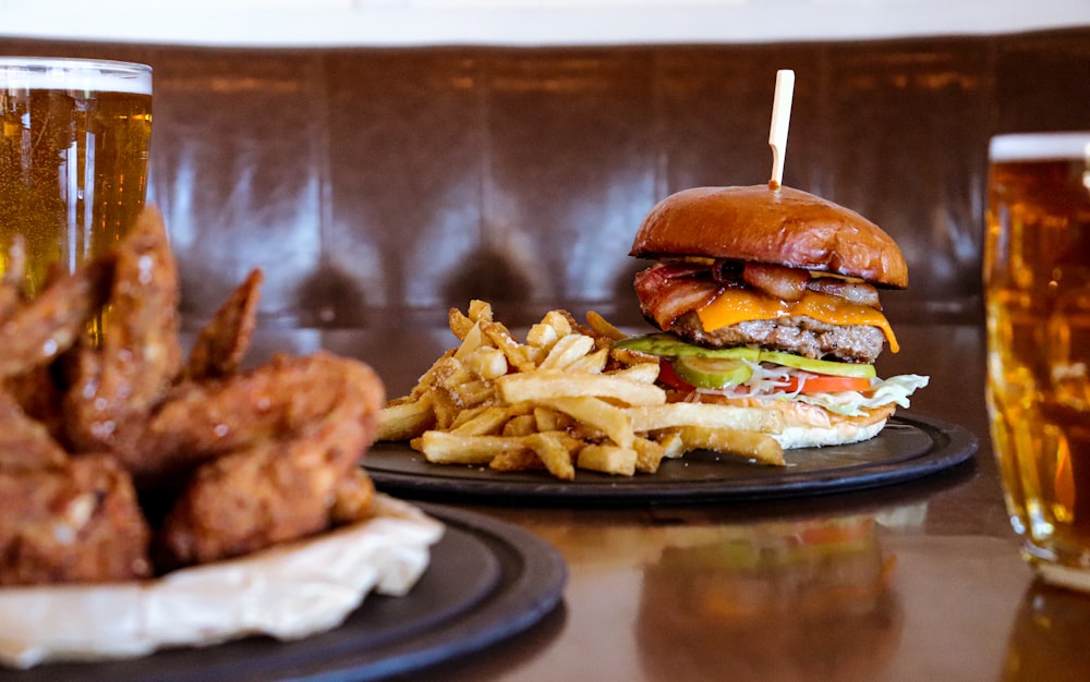 burger with fries on black ceramic plate