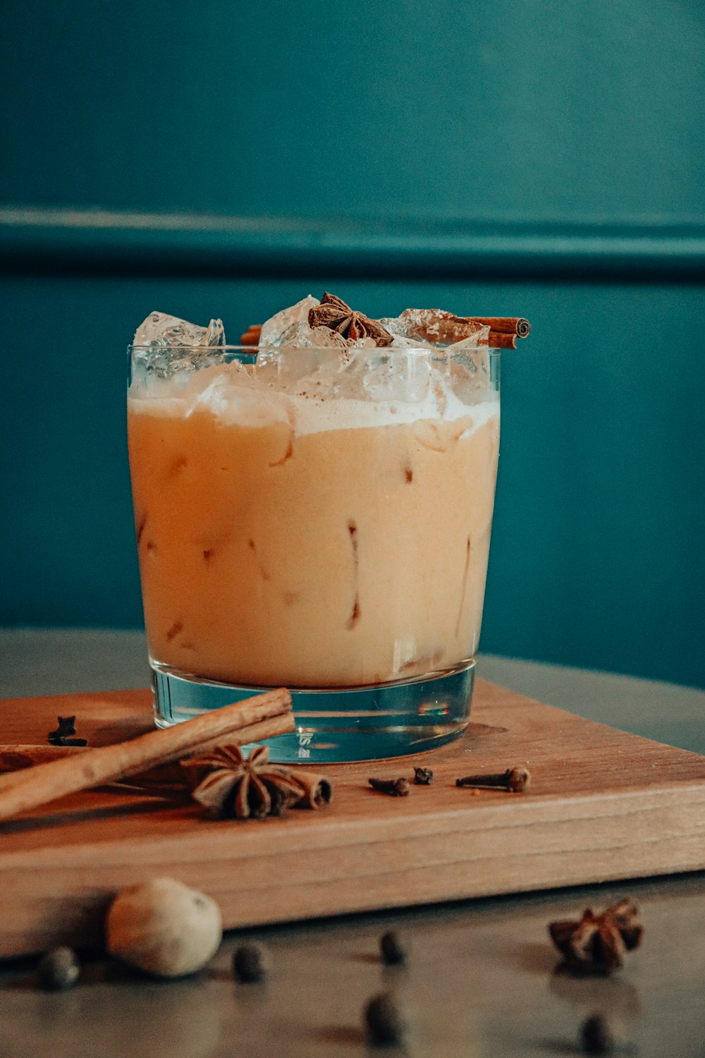 clear drinking glass with brown liquid and ice