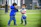 Two children happily playing outdoors in colorful clothes